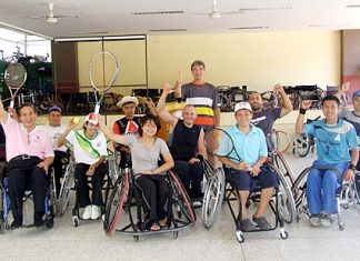 Udomchok Churat, Director of the Pattaya Redemptorist Vocational School (far left), and tennis trainers Dr. Horst Guentzel (standing rear), Michael Jereniasz (6th left)and Carlo Emanuel Tresch (3rd right) pose with students at the school on Thursday, October 6.