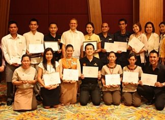 Employees of the Centara Grand Mirage Beach Resort Pattaya, under the watchful eye of Lily Eduardcoce (standing left) the training manager, pose proudly with their certificates of achievement at the end of their successful training sessions. Andre Brulhart (standing 5th left), the general manager, presented his staff with their recognitions, thanking them for their dedication for excellence in five star services.