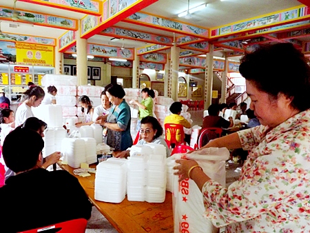 Volunteer spirit - Sawang Boriboon Pattaya Foundation members and friends pack relief supplies.