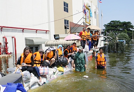 Sandbags didn’t keep the flood waters out of this factory, but they do supply a somewhat dry spot for people to use whilst waiting to be rescued.