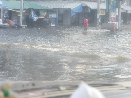 Flood waters rage in the outskirts of Bangkok.