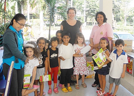 Miss Lily’s children are pictured here donating money from their bake sale to the staff at Rangsit Home for Babies.