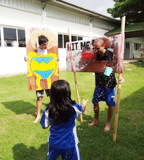 Mr Holloway faces the onslaught of wet sponges.