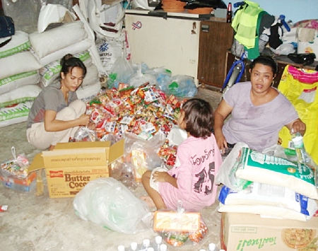 Ladies & young girl putting packages together.