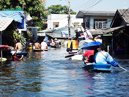 What was once a quiet little soi in this Ayuthaya hamlet is now a navigateable klong.  Our staff reporters recently tagged along when Securitas Security Services (Thailand) Co. spearheaded a Pattaya relief group voyage to deliver much needed supplies to flood victims there.  