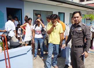 Pol. Lt. Col. Nanthawut Suwanla-Ong leads the gamblers out of the rented house.