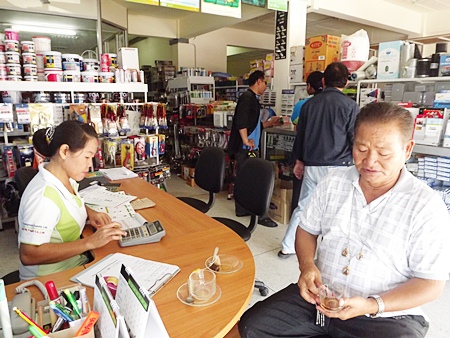 Pathum Thani resident Praset Saengmai-on (right) says, “I lost my construction job and my home has been flooded with so much water, it has almost reached the roof.”