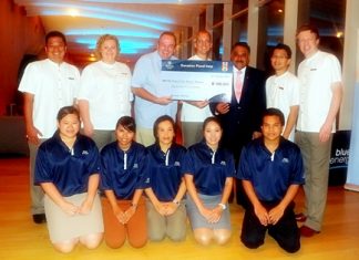 Hilton Pattaya General Manager Harald Feurstein (4th left), flanked by Robert Denzel, Assistant Governor of Rotary District 3340 and Past District Governor Pratheep S. Malhotra, with hotel management and the Blue Energy Committee members, donates 100,000 baht to the Rotary Club of Taksin Pattaya for their flood-relief efforts.