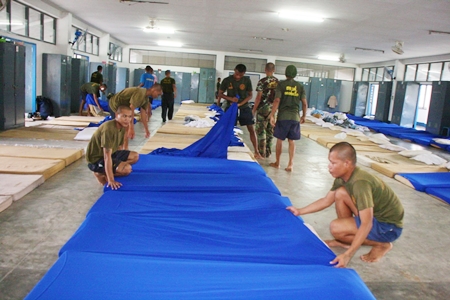 Navy cadets prepare beds for the incoming victims of devastating floods in Bangkok and beyond.
