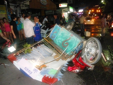 Bystanders gawk at the overturned papaya-poke-poke cart. 