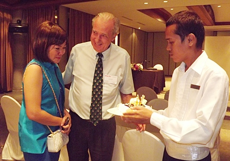 Som is moved as the Doc beams on being presented with his birthday cake.
