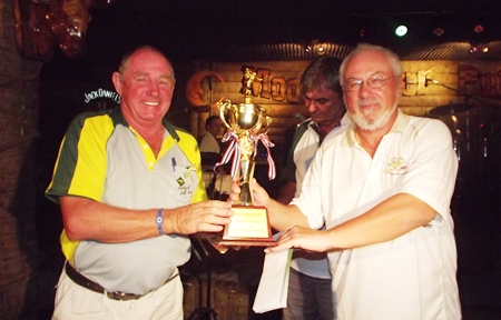 Bob Philp (left) receives the Thai Garden Resort Cup from rival captain, Helmut Wolf.