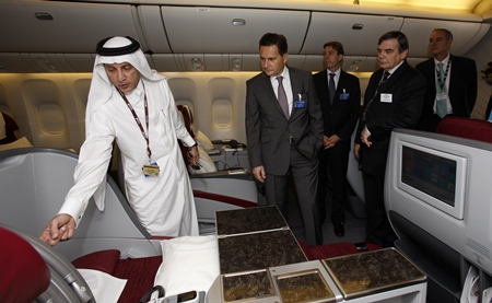 Qatar Airways Chief Executive Officer Akbar Al Baker, left, with French Minister of Industry, Energy and the Digital Economy, Eric Besson, onboard one of the airline’s Boeing 777’s on static display at the Dubai Air Show.
