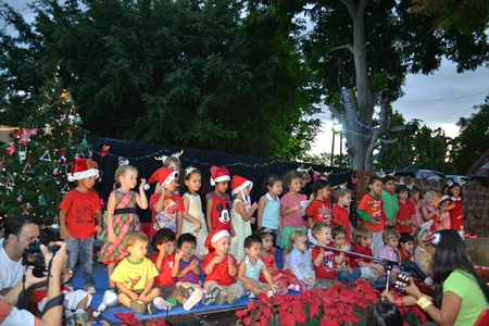 The children happily entertain their parents with “Jingle Bells Rock!”