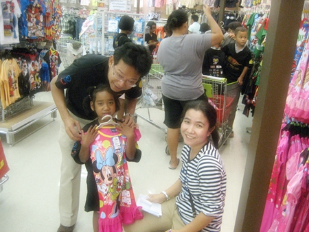 This youngster is excited to be given a beautiful Minnie Mouse dress.