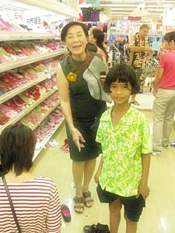 Toy from the Human Help Network Foundation Thailand helps one youngster pick out a pair of shoes.