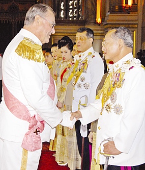 His Majesty the King is congratulated by Prince Henrik of Denmark at the Ananda Samakhom Throne Hall in Bangkok Monday, June 12, 2006.