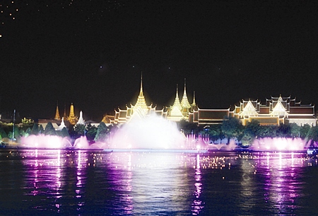The Grand Palace forms a stunning backdrop as illuminated fountains and floating lanterns mark the passing of the Royal Barge Procession dutring the 60th anniversary celebrations of His Majesty the King’s ascension to the throne in Bangkok Monday, June 12, 2006.