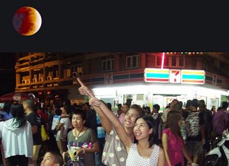 Pattaya denizens gather in the thousands to watch a total lunar eclipse on Constitution Day, Dec. 10. The full moon turned blood red during the last total lunar eclipse until 2014.