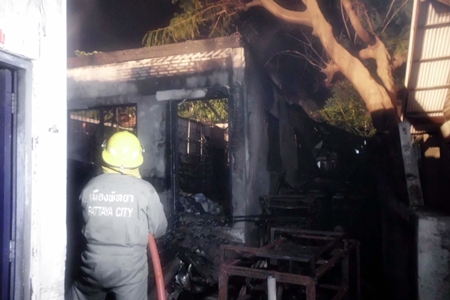 Firefighters put out the remaining embers in a hotel storage room fire that caused approximately 300,000 baht in damage. 