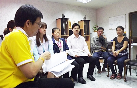 Maneeporn Phukrongthung and her husband Namchai (both seated right) listen to Dr. Narongsak Ekawatnakul (left), director of Banglamung Hospital as he tries to explain what happened. 