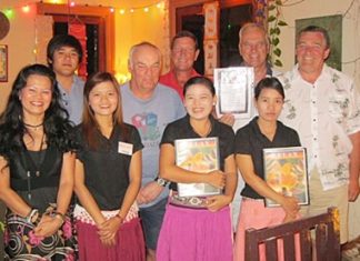Tuesday winners pose for a photo with the staff at the Relax Bar.