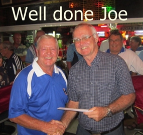 Joe Mooneyham (left) receives his B Flight winning prize from PSC President Tony Oakes.