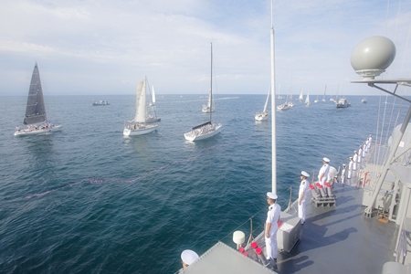 The 25th Phuket King’s Cup Regatta fleet sails past HTMS Chonburi in salute of His Majesty the King’s 84th birthday, Monday, December 5. (Photo/Guy Nowell) 