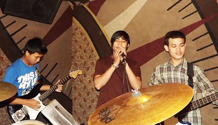 Wuthisak (right) plays with friends in the Teamshow band. 