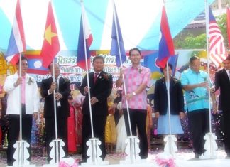 Mayor Itthiphol Kunplome and other officials plant flags to officially open the new ASEAN study center at Pattaya School #4.