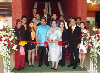 Culture Minister Sukumol Kunplome cuts the ribbon to officially open the new Miniature Thai Royal Barge Performance Center.