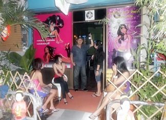 Banglamung Police Superintendent Col. Somnuk Changate (center) leads an inspection of Naklua karaoke bars.