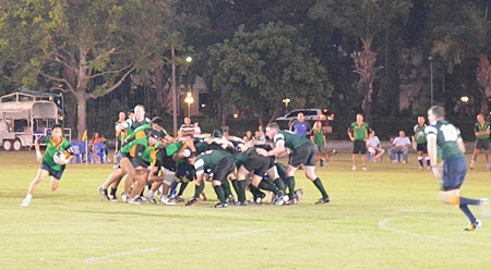 Tong (far left) breaks free from the back of the scrum to attack the U.S. Navy back line.