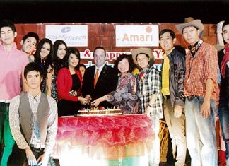 Pierre Andre Pelletier (centre), GM of the Amari Watergate Bangkok joined by many celebrities cuts the cake during the Xmas & New Year Cowboy Night Party organized by Clark Hatch Fitness Center.