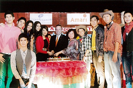 Pierre Andre Pelletier (centre), GM of the Amari Watergate Bangkok joined by many celebrities cuts the cake during the Xmas & New Year Cowboy Night Party organized by Clark Hatch Fitness Center.