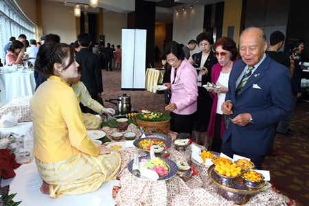Past District Governor Gen. Saiyud Kerdpol stops to taste the delicious Thai sweets on display.