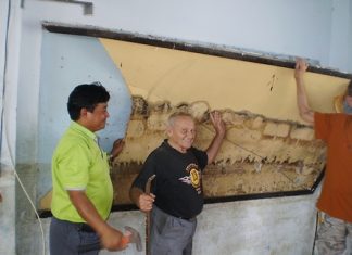 Bernie and the school principal take part in a small ceremony by removing the first damaged wall board to celebrate the beginning of the project.