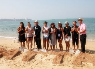 Thai tennis players, city officials and tournament organizers spell out Pattaya in the sand.