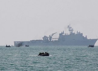 Armed forces leave their transport ship and head for Had Yao Beach.