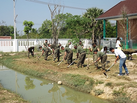 US Marines battle the heat while tilling an area behind the Child Protection and Development Center in Huay Yai to be used as a vegetable garden.