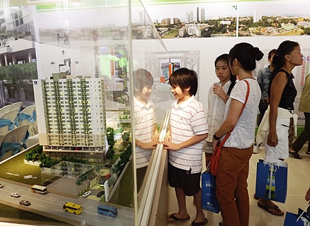 Visitors look at a scale model of the development. 