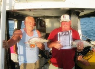 Leif Jansson (right) and Ken Woolley (left) hold up their prize catches.
