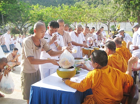 Prisoners at Sattahip Prison offer alms to monks and observe the 8 day religious precepts.