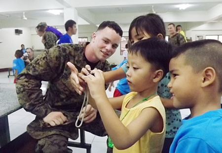 The children at Pattaya Orphanage certainly enjoy play time with US soldiers.