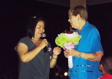 Nancy Bendburn presents a bouquet to Piangta Chumnoi, the benevolent director of Ban Jing Jai Foundation.