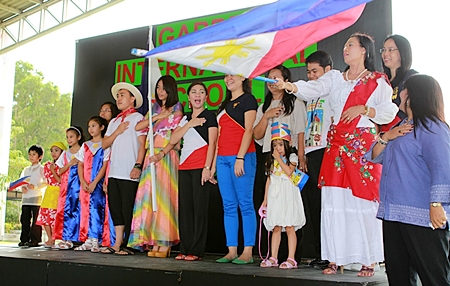 Filipinos standing proud as they sing their national anthem.