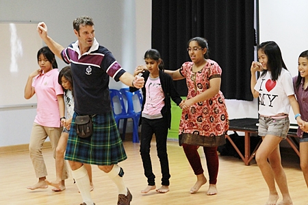 In the morning activity, Mr. Andrew Gordon teaches Scottish dance to the students.