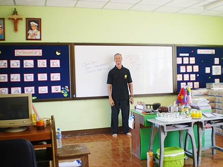 Woody stands in front of the whiteboard in one of the new classrooms.