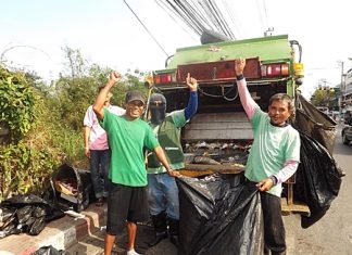 Somjit and fellow garbage collectors at work, picking up refuse to be carted away.