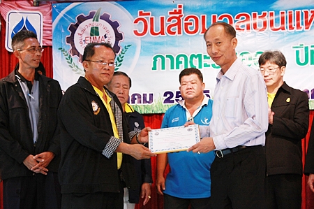 Padungsak Tantraworasilp, president of the Eastern Mass Media Association of Thailand, receives his prestigious award from Chonburi Governor Khomsan Ekachai.